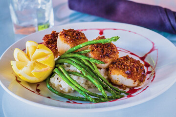 crusted scallops on a bed of risotto with roasted asparagus