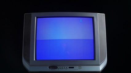 Vintage CRT Television with Blue Screen Display