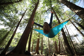Carefree Girl in a Hammock Reaching for the Sky