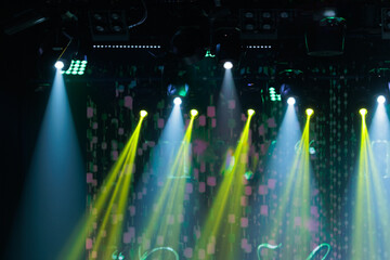 An empty stage of the theater, lit by spotlights and smoke before the performance