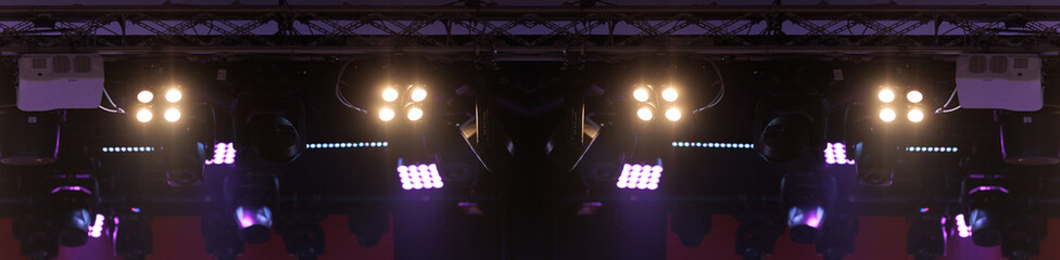 An empty stage of the theater, lit by spotlights and smoke before the performance