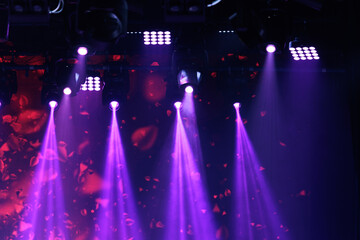 An empty stage of the theater, lit by spotlights and smoke before the performance