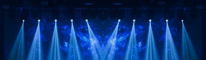 An empty stage of the theater, lit by spotlights and smoke before the performance