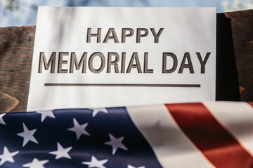 Fototapeta premium Memorial Day Sign with American Flag on Wooden Background