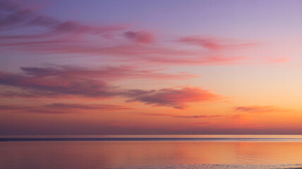 Fototapeta premium Stunning Sunset Colours Over Calm Water