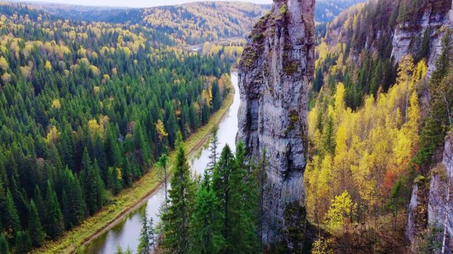 View of the Usvinsky pillars and the river in autumn from above.View of the Usva River, flowing through a rocky area in the Perm Region, unique relief forms, stone pillars from a bird's-eye view.Drone