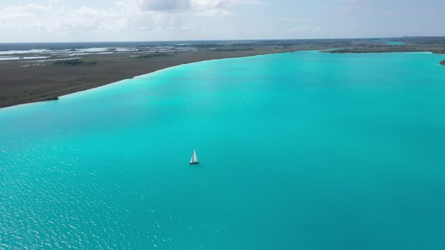 bacalar lagoon and a sailboat in the middle