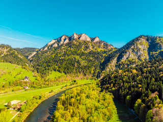 Peak Tri Koruny or Trzy Korony during day with green meadow and trees in spring. Pieniny National park in Slovakia and Poland . © Zedspider