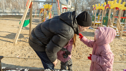 Little girl, quarreling and other crying during their walking in winter.