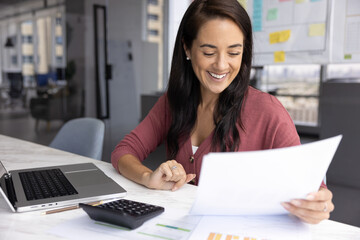 Enjoying finance growth. Happy smiling millennial woman project manager bookkeeper read statistic...