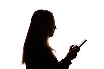 Silhouette of young woman using smartphone on white background