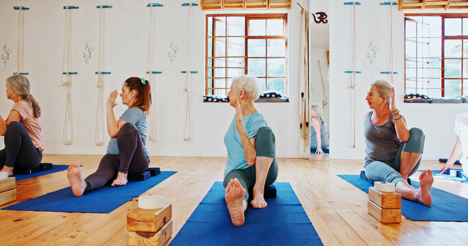 Group, senior people and exercise for yoga for fitness, flexibility and spiritual wellness. Elderly women, seated twist pose and community pilates, holistic practice and body balance at health club