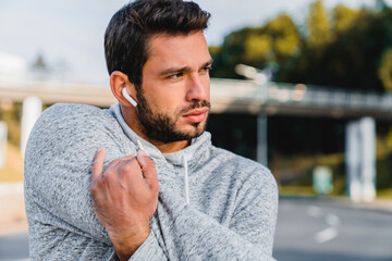 Fitness, runner or Caucasian man stretching in city for running training, cardio exercise or...