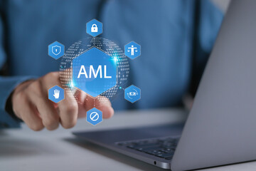 AML, Anti money laundering financial bank concept. Person using laptop with AML icons on virtual screen for anti money laundering regulations.