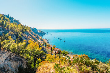 Cityscape of town of Taormina, Sicily with beautiful rock cliff and  beach.