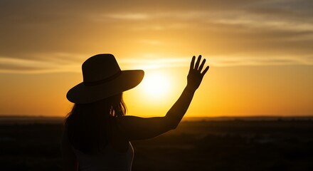 Fototapeta premium Woman Shielding Sun at Sunset