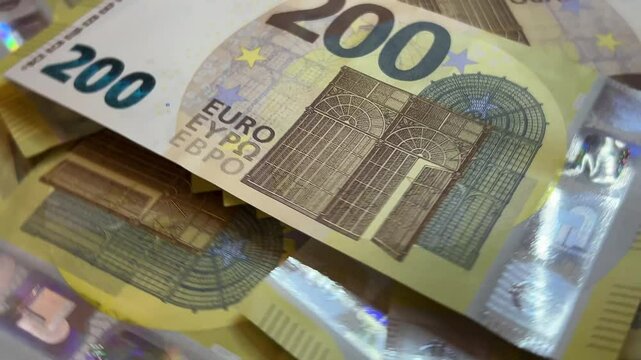 Euro banknotes background spinning counterclockwise 200 euros cash