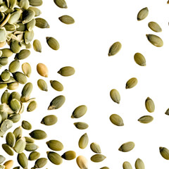 Scattered pumpkin seeds close up. Showing the texture and colors of seed. 