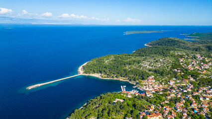 Fototapeta premium Aerial view of Veli Lošinj (Losinj), charming historic town on the island of Mali Lošinj, Croatia. Colorful old architecture, narrow streets, and crystal Adriatic waters create stunning coastal scene