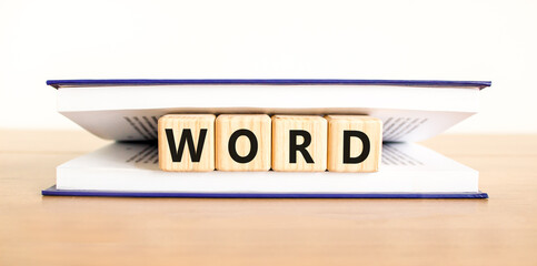 Word symbol. Concept word Word on beautiful wooden blocks in book. Beautiful wooden table white...