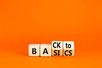 Back to basics symbol. Concept words Back to basics on wooden block. Beautiful orange table orange background. Business back to basics concept. Copy space.