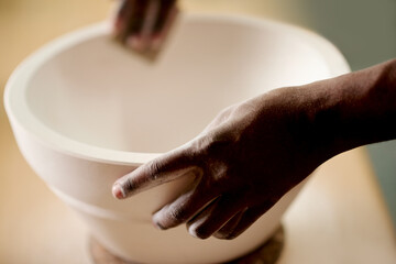 Hands, pottery and person with ceramic in workshop with manufacturing process for small business. Creative, design and ceramist molding product for handmade sculpture with talent, skill and art.