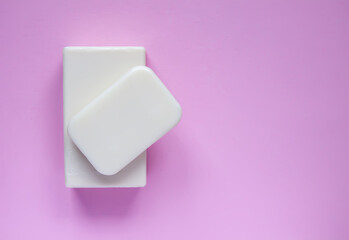 Natural handmade organic soap bars on a pink background.