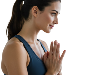 Female yoga instructor holding tree pose on a clean white background with soft lighting.
