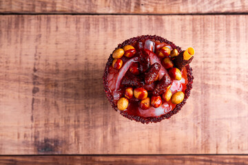 Crazy little glass, a mixture of sweet, salty and spicy ingredients. Typical snack from Mexico