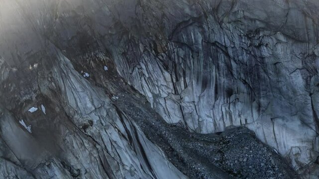 Aerial View of Rocky Mountainside with Snow Patches in British Columbia, Canada
