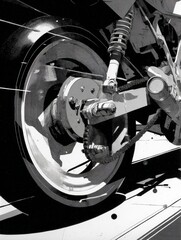 Close-Up of Motorcycle Wheel Mechanics: Detailing Suspension, Gear & Brake System in Black and White for Industrial Design Enthusiasts