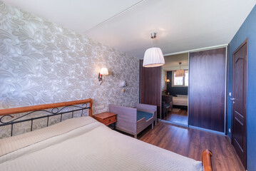Cozy Bedroom Interior With Wooden Furniture and Stylish Decorative Wallpaper