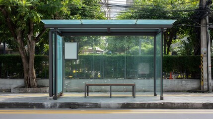 A bus stop with a bench and glass walls on the side of a street with trees and power lines above it