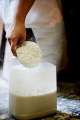 Workshop, art and hands with glaze, mixing and process for texture of pottery, creative and artisan. Startup, artist and person with liquid for production, craftsmanship and entrepreneur with powder