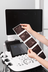 The doctor examines the ultrasound images at the clinic