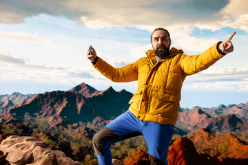Pleased nature lover recording a video to document his hiking activity on social media, being...