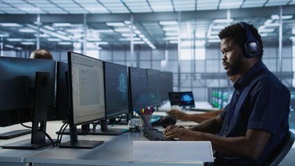 Engineer in server room looking over documents, developing disaster recovery plans ensuring minimal downtime. Worker reading paperwork in data center, using analytics to monitor performance, camera A