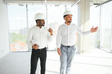 Indian and African American engineers at construction site