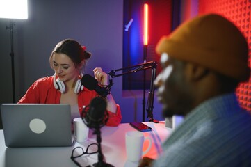 Man and woman livestreaming online discussion on podcast episode, recording live for internet...