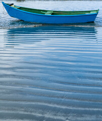 Small blue fishing boat on the beach of Pereque in Guaruja, coast of Sao Paulo state, Brazil