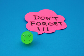 Happy face next to a speech bubble with the phrase DONT FORGET with exclamation points