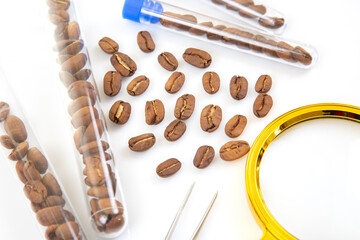 Close-up of coffee beans being analyzed in a laboratory setting with scientific tools and test tubes