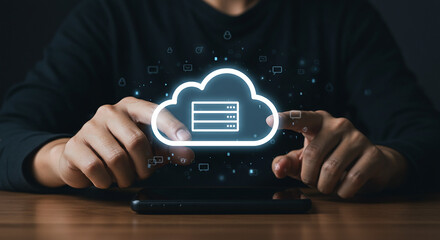 Person interacting with a cloud computing icon on a smartphone with a wooden surface below it