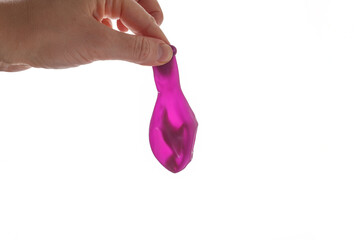 Balloon containing dinosaur toy prepared for water filling, step in frozen egg activity for kids, ideal for content creators, educational blogs, toy stores, DIY craft visuals, science learning tools,