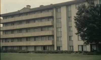 A tall building with multiple windows on the facade