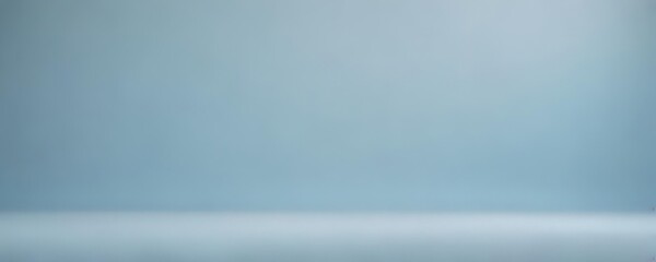 Soft, hazy light blue abstract backdrop with subtle gradient and textured effect ,  mist,  calming