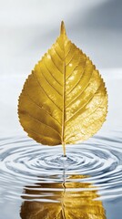 Golden leaf floating on water, creating ripples, suggesting tranquility and a serene moment