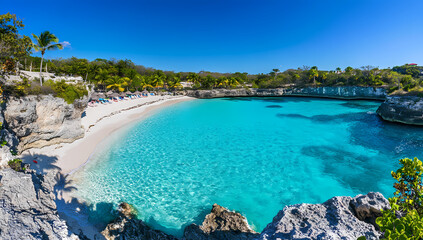 Fototapeta premium Paradise Beach: Captivating coastal scene features a tranquil turquoise bay cradled by rugged cliffs, lush vegetation, and an expansive, sun-kissed shoreline.