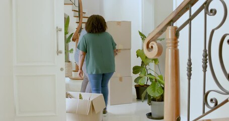 African American couple unpacking boxes in new home, smiling and enjoying moment