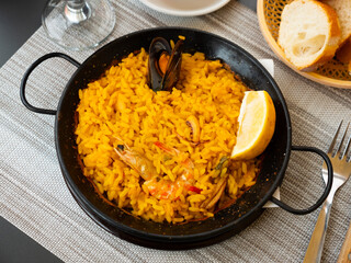 National Spanish rice dish paella tinted with saffron. Prepared with olive oil and seafood